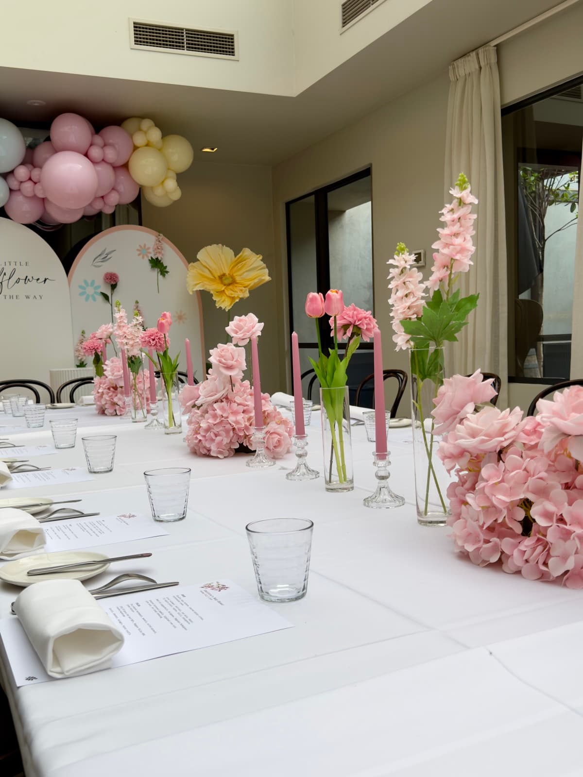 Baby shower event styling with pastel decorations and balloon arrangements