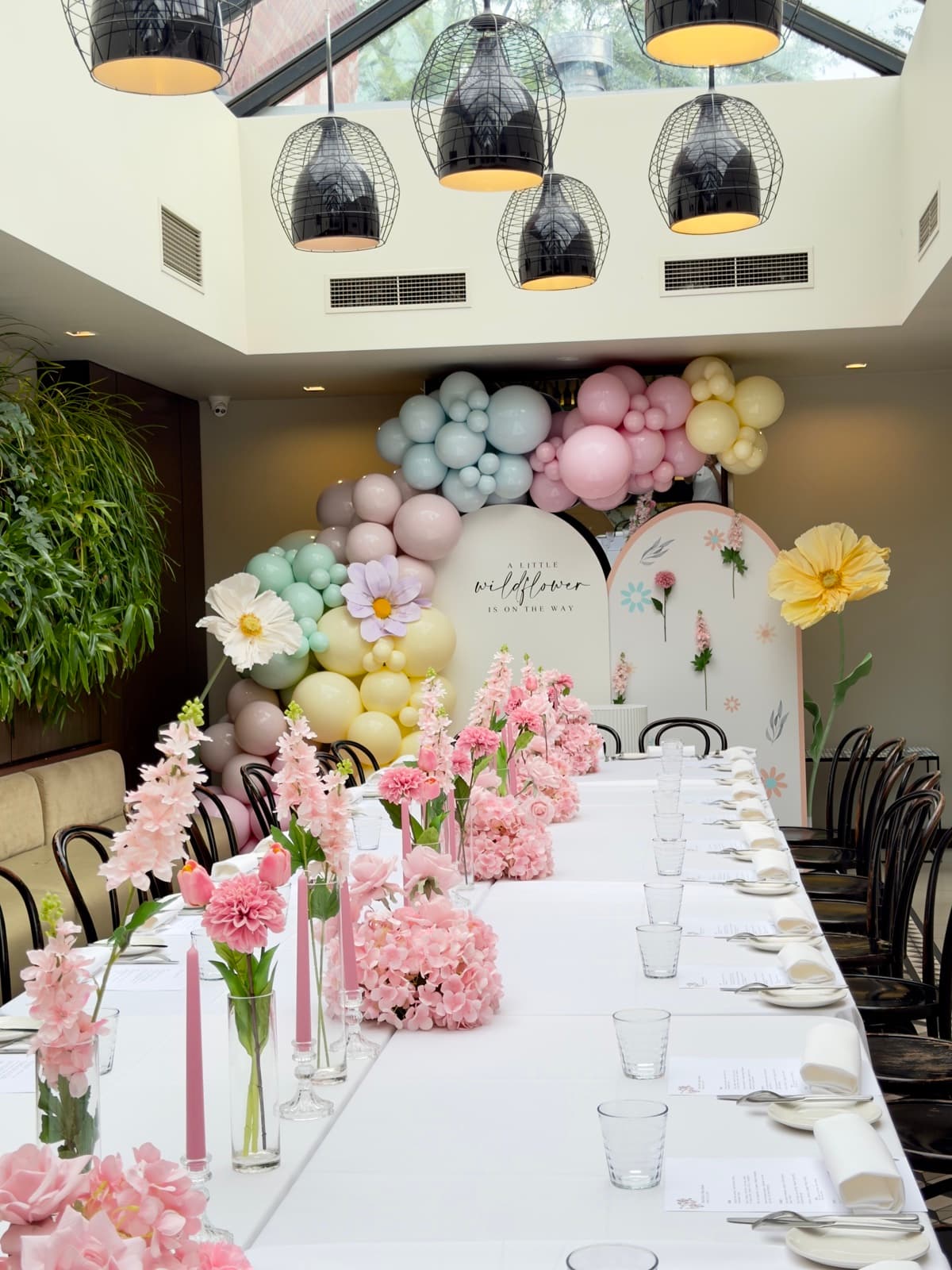 Baby shower event styling with pastel decorations and balloon arrangements