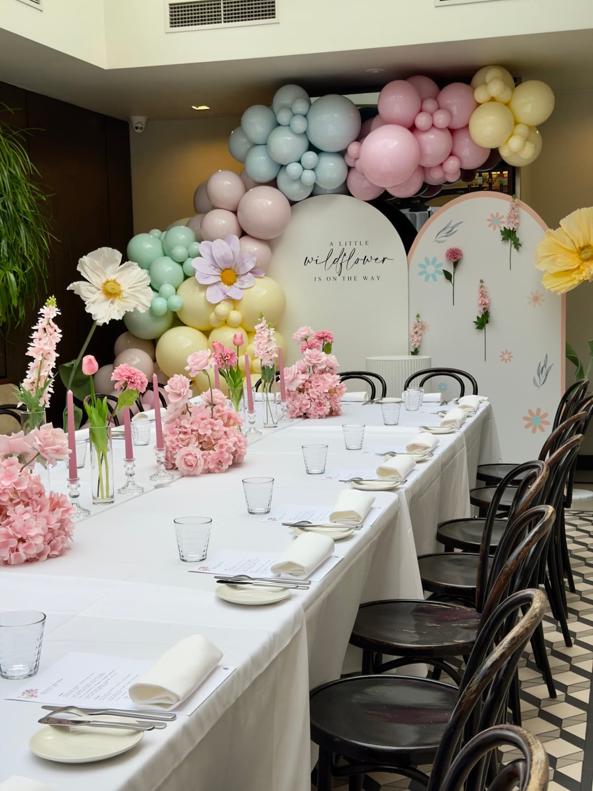 Baby shower event styling with pastel decorations and balloon arrangements