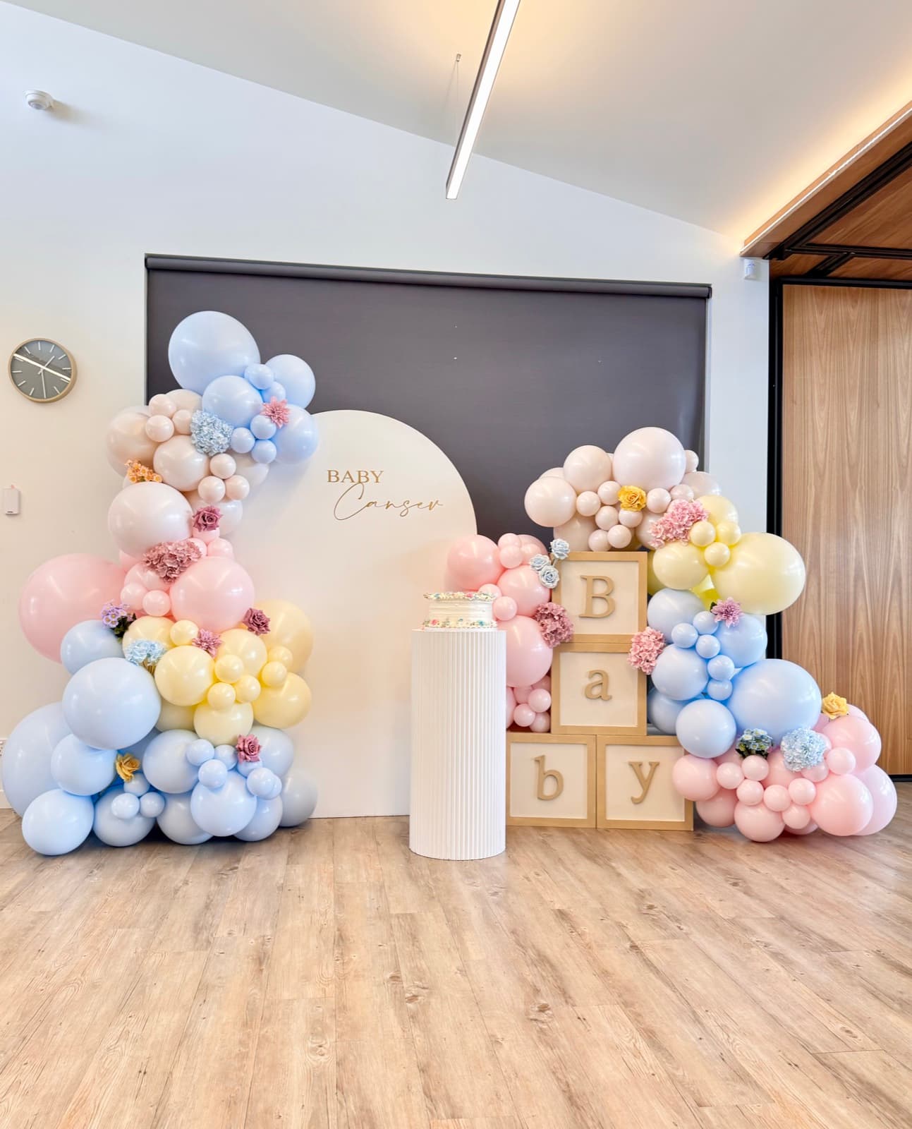 Baby shower event styling with pastel decorations and balloon arrangements