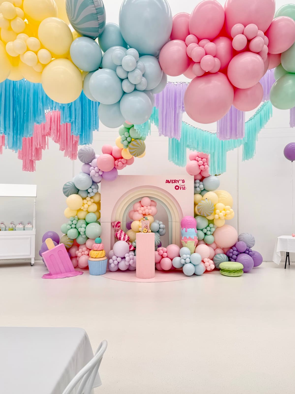 Birthday party styling with balloon installations and themed decorations