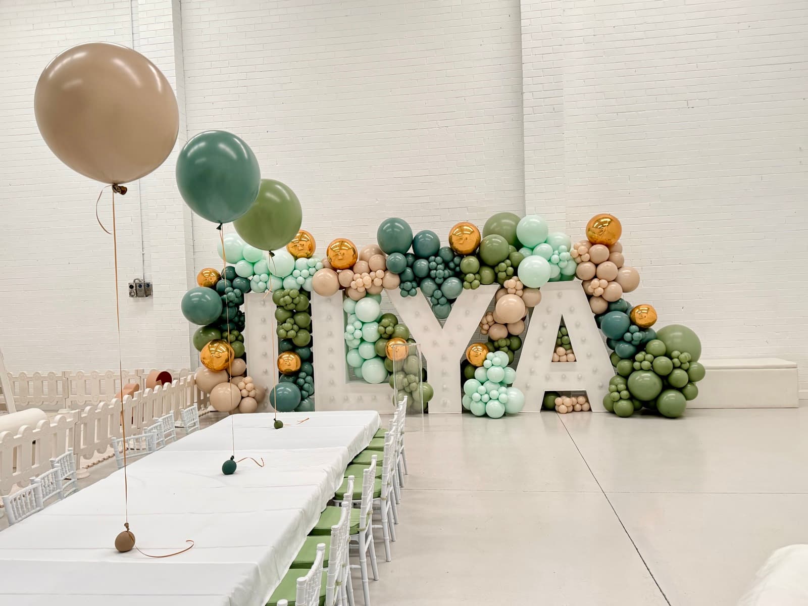 Birthday party styling with balloon installations and themed decorations