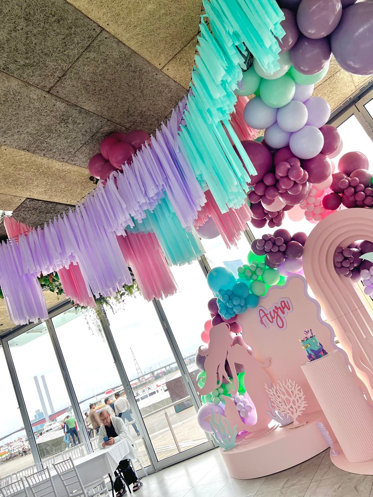 Birthday party styling with balloon installations and themed decorations
